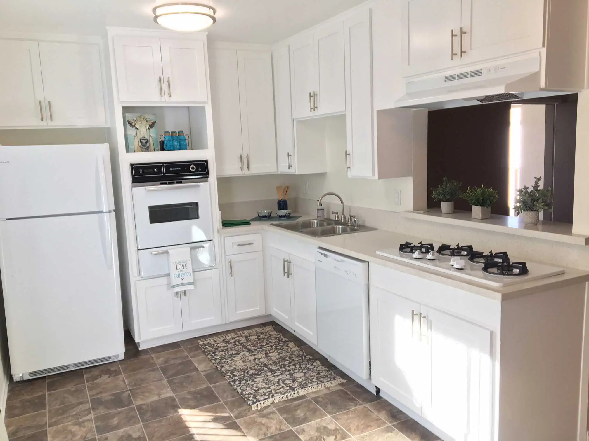 Magnolia Place renovated kitchen with white shaker cabinets