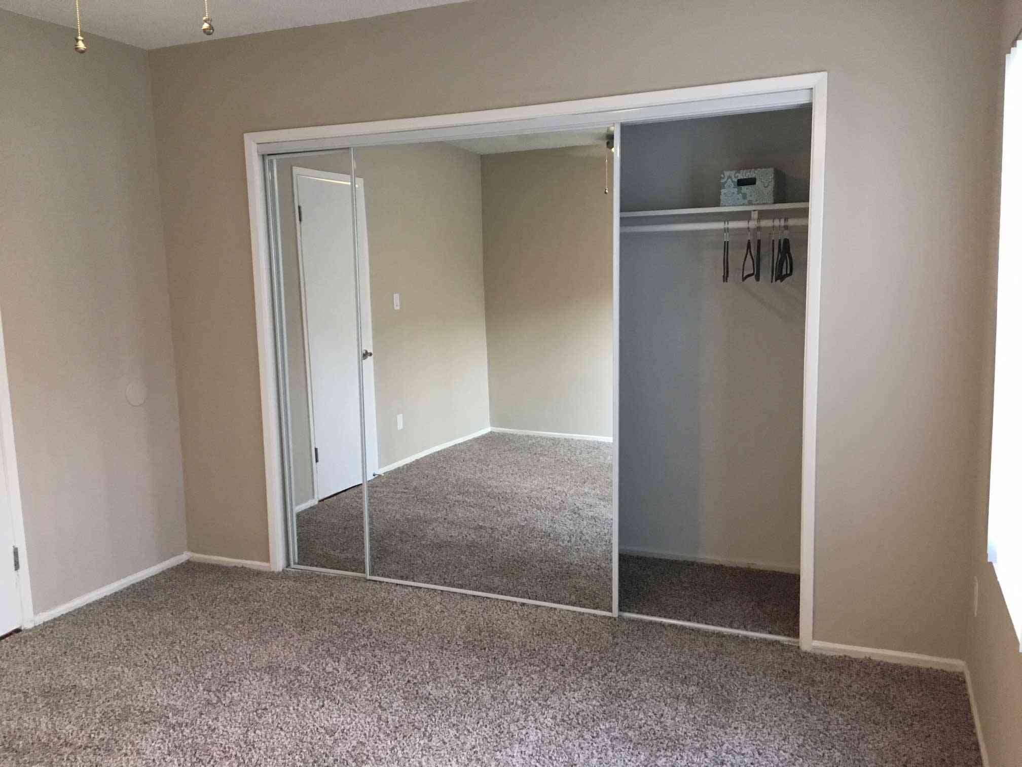 cozy bedroom with mirrored sliding closet doors